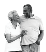 Older African American female and male couple hugging smiling